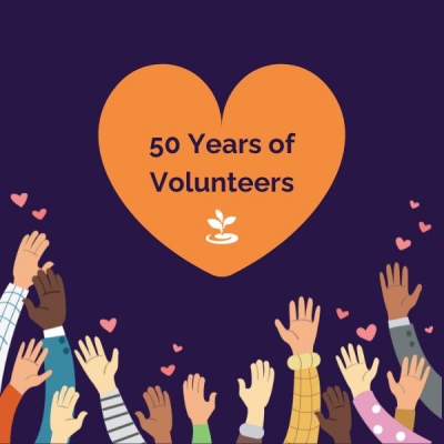 Large orange heart with 50 Years of Volunteers, sprout logo - diverse hands reaching up with little pink hearts
