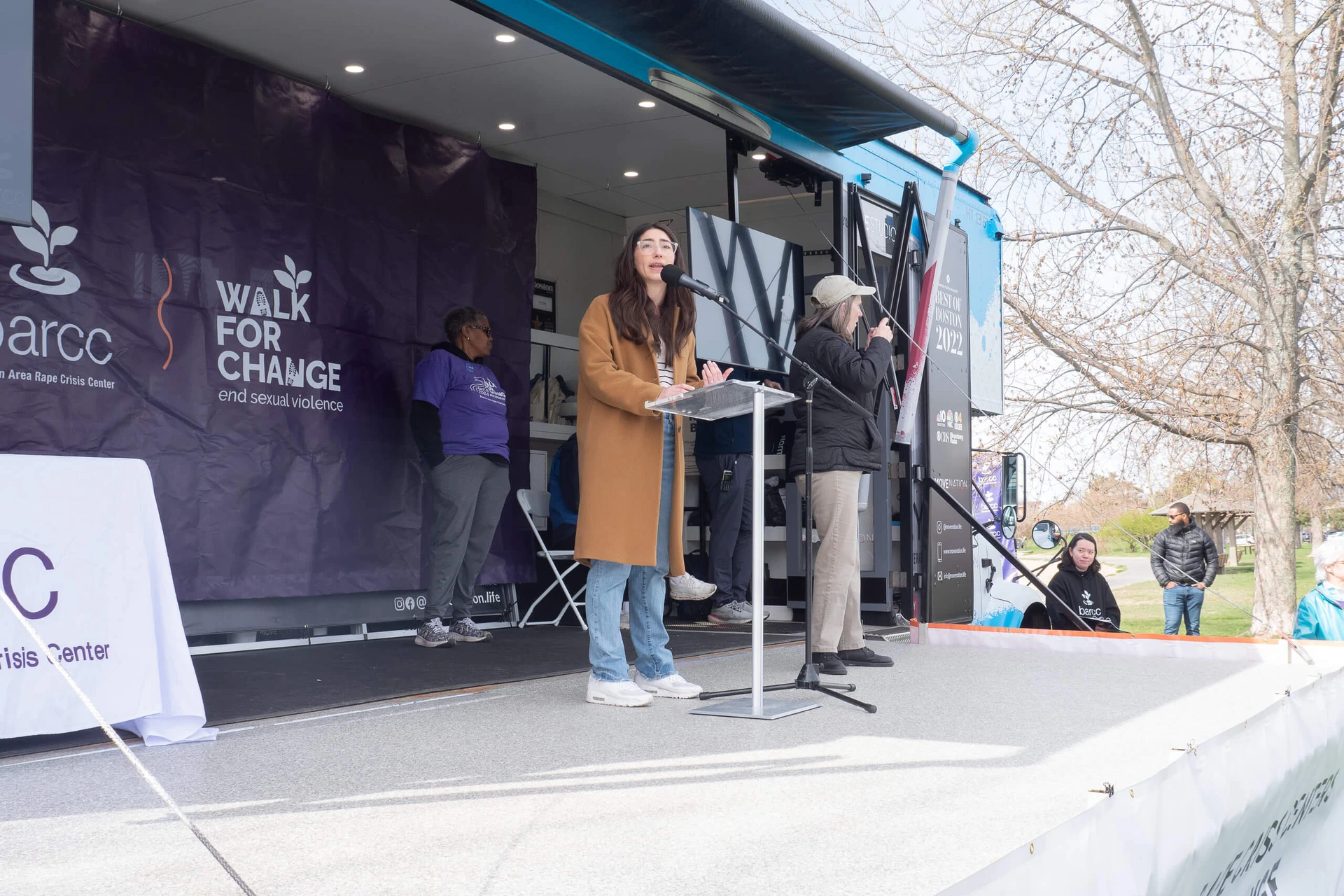 20240420-86 People on a stage are speaking at the "Walk for Change" event, emphasizing the importance of education and prevention of sexual violence to foster a safer community.