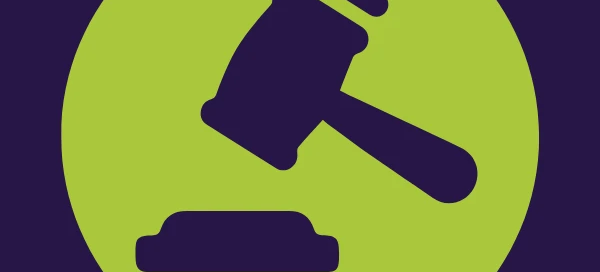 A green circle with a black gavel symbol stands out against a dark blue background, symbolizing justice and support like Boston's dedicated rape crisis center.