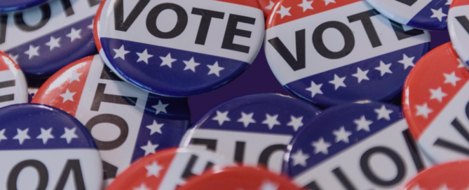 A pile of red, white, and blue buttons with the word "VOTE" and stars on them, perfect for teaching teenagers about civic engagement and fostering healthy relationships through active discussions.