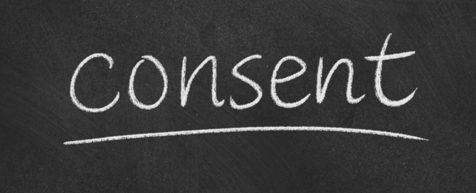 The word "consent" is written in white chalk on a black chalkboard, with a line drawn underneath it, honoring Dr. King's enduring legacy of striving for justice and equality.