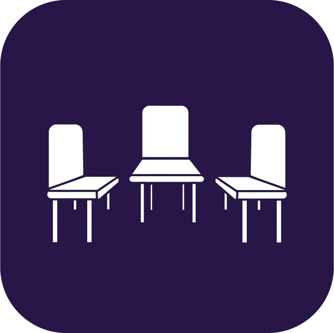 Icon depicting a table with three chairs, two on the sides and one at the head, against a dark purple background, symbolizing the collaborative spirit of Boston services.